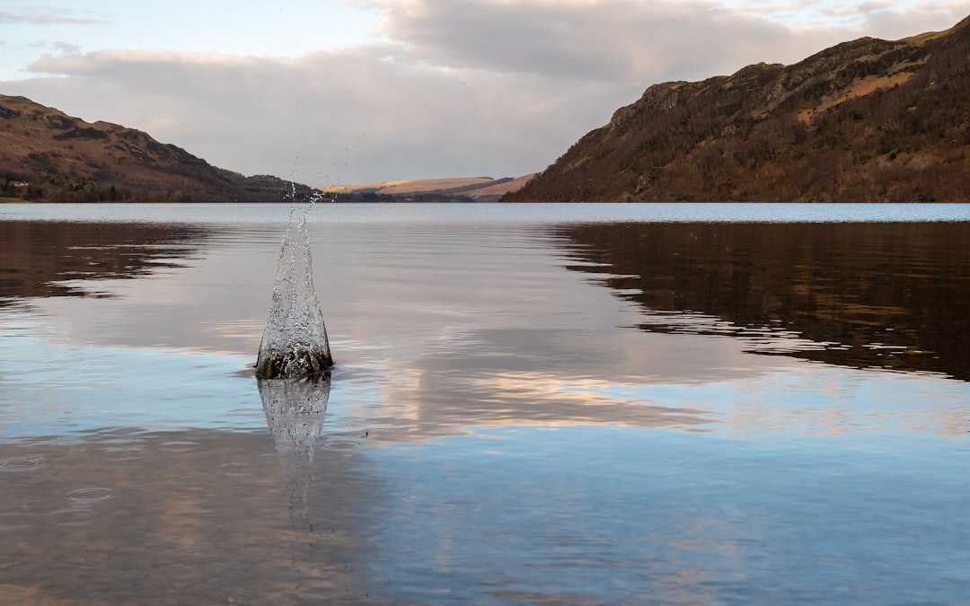 Peaceful rock in the clear waters of Ullswater lake